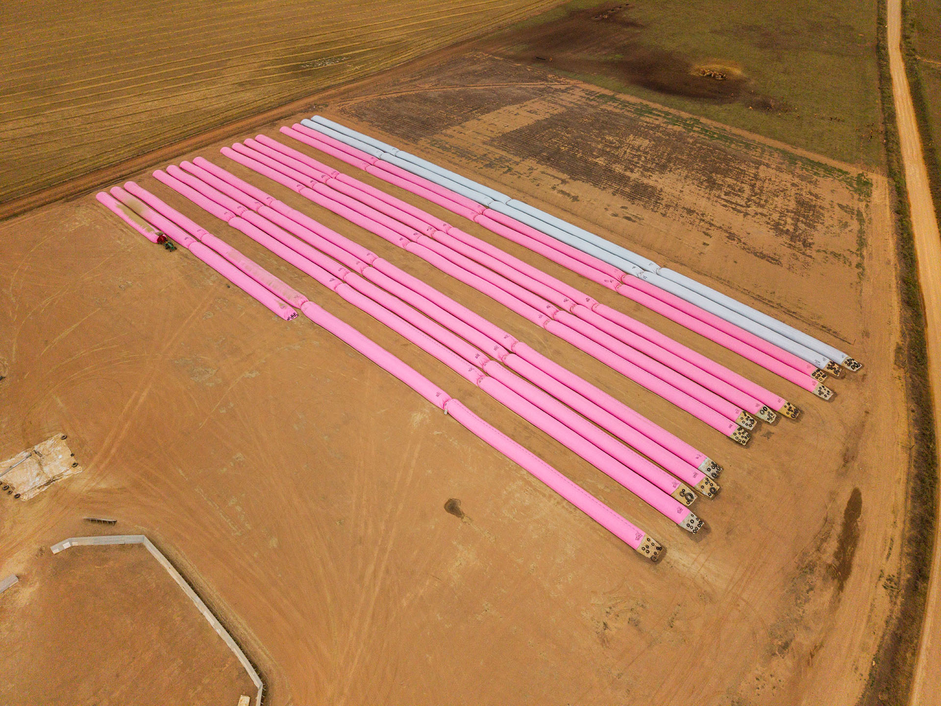 Aerial view of pink grain storage bags at Overberg Agri's Protem grain facility.